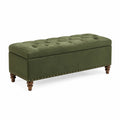 Banc de rangement en velours vert avec pieds en bois